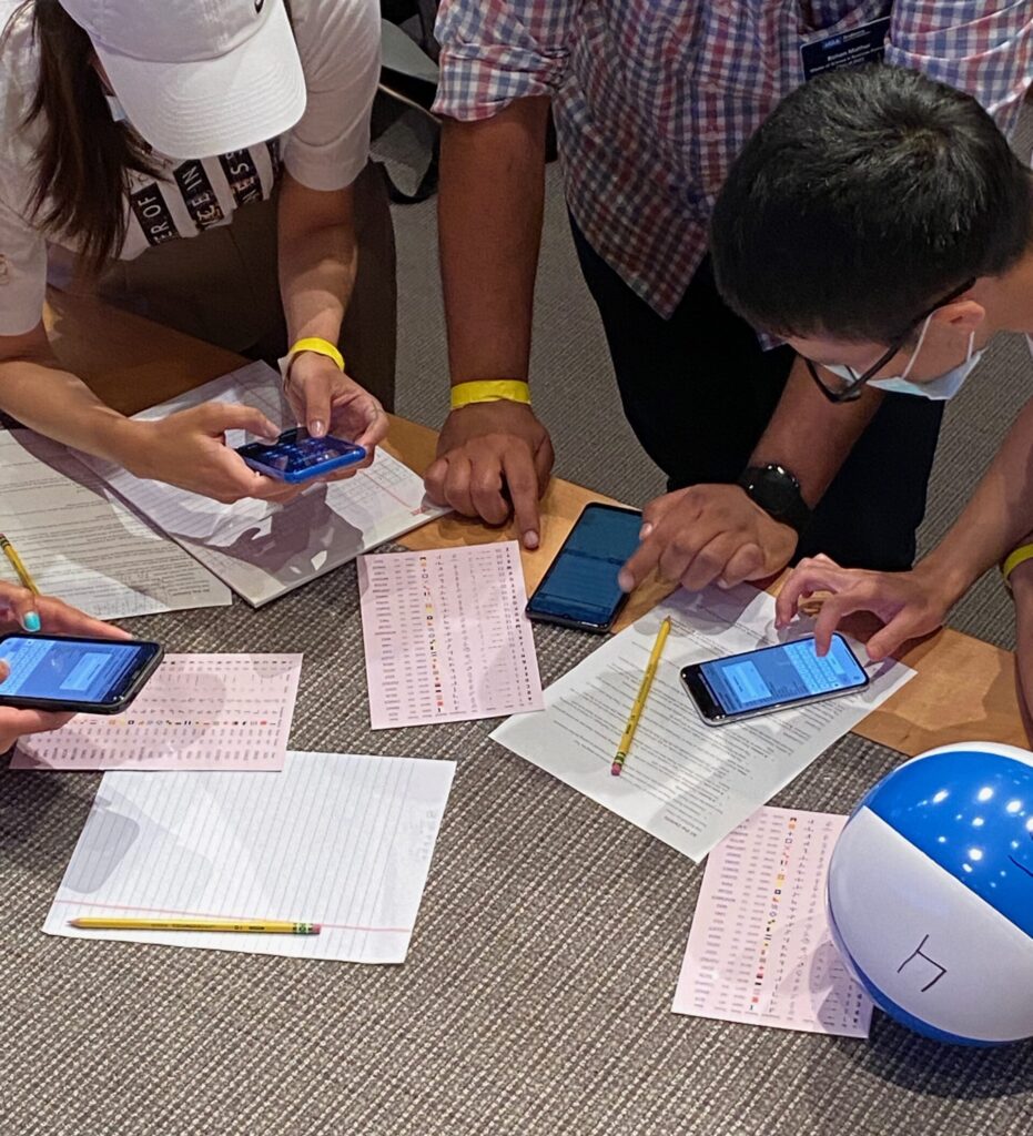 Close-up of puzzle solvers decoding a message.